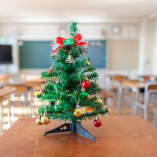 A Christmas tree in an empty classroom